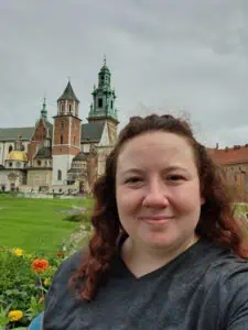 a picture of a person in front of buildings in Krakow
